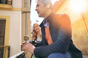 Man and woman taking pictures while touring building