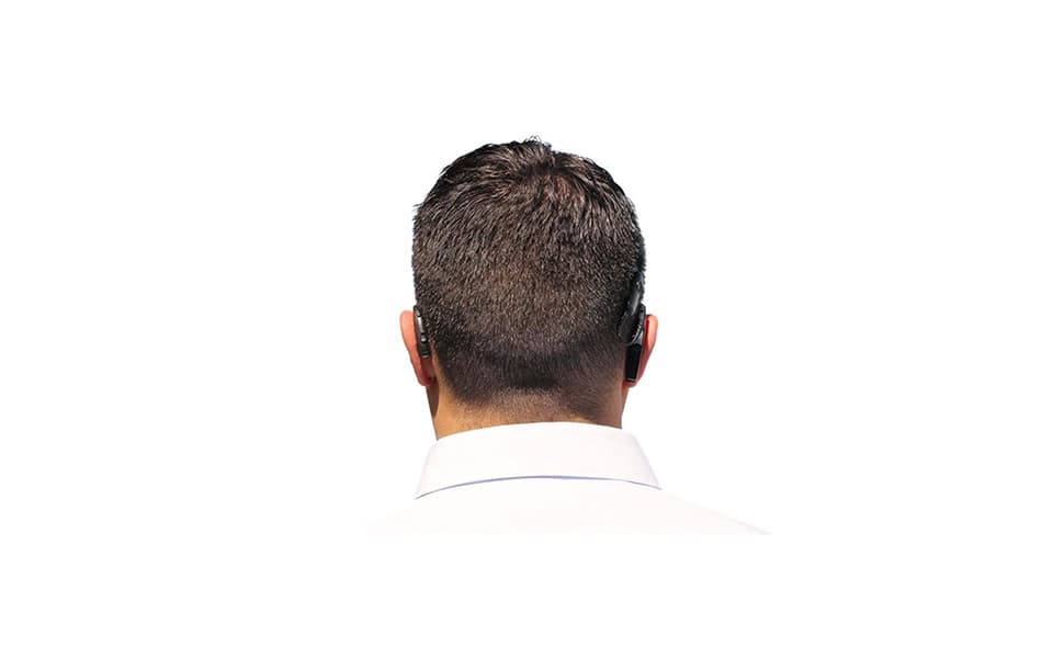 A man wearing bimodal hearing aids, different devices for each ear.