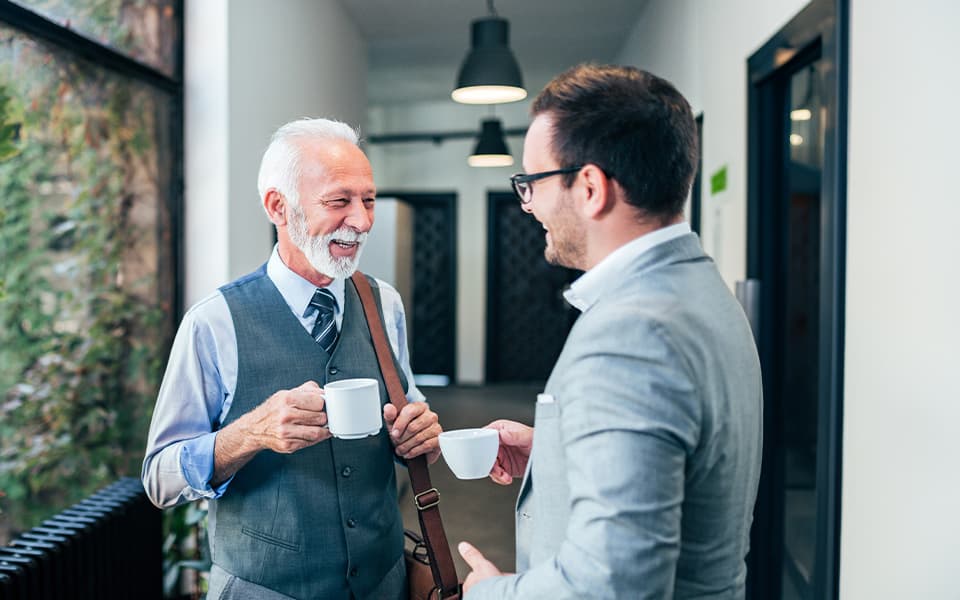 Coworkers on a break talking and drinking coffee