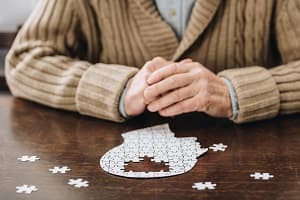 Senior man working on dementia brain puzzle