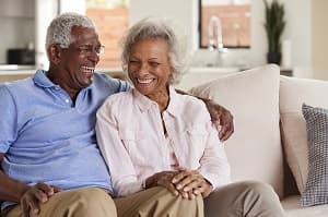 Happy senior couple sitting on couch
