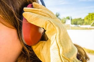 Worker wearing ear protection and gloves