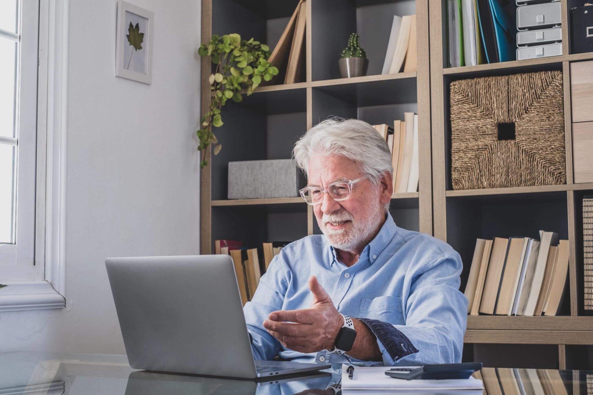 Man on his laptop looking happy about a how-to video he has found