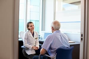 Image of a man talking to an audiologist.