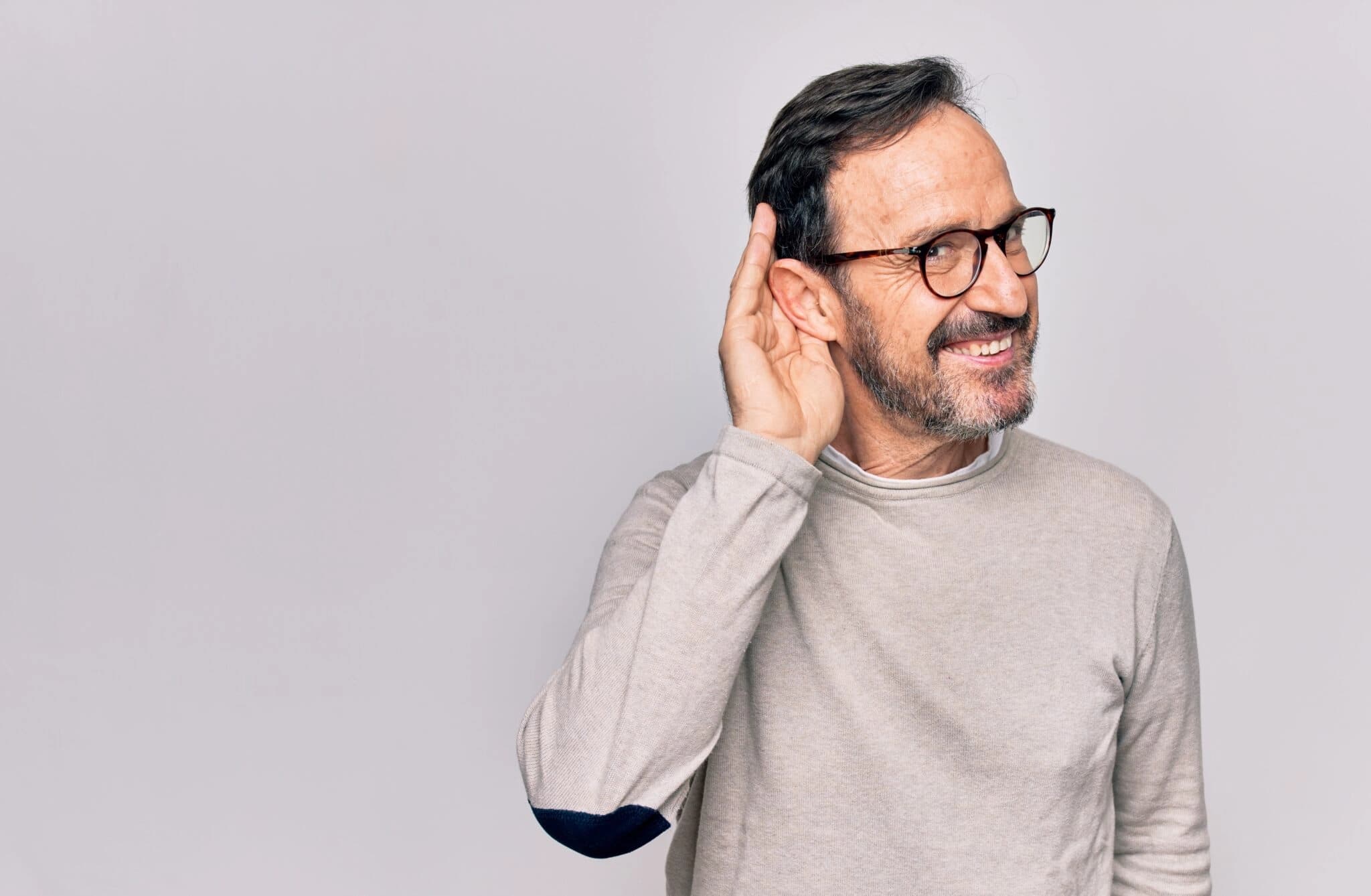 Man listening with his hand next to his ear