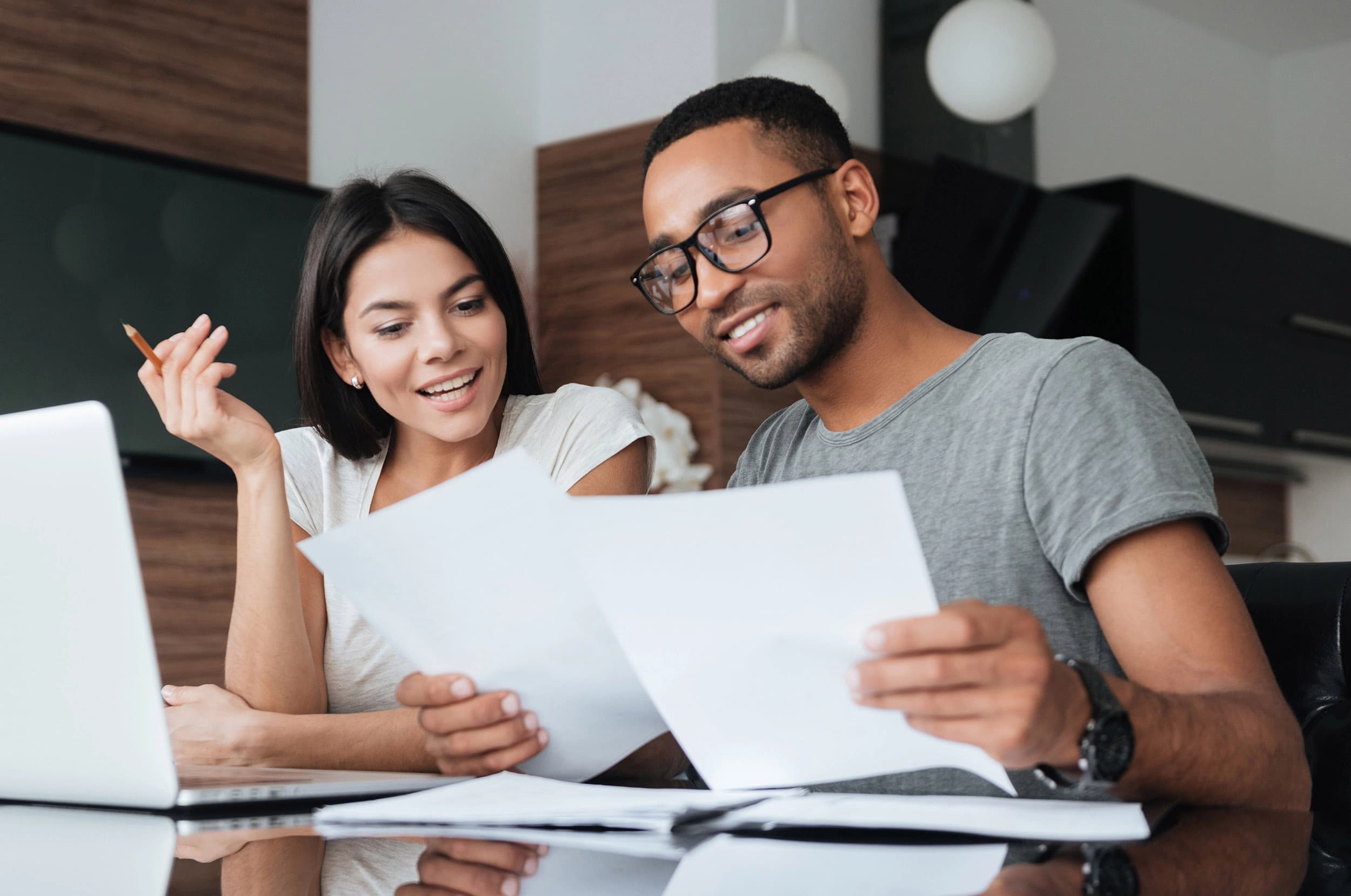 Happy young couple looking over financing documents