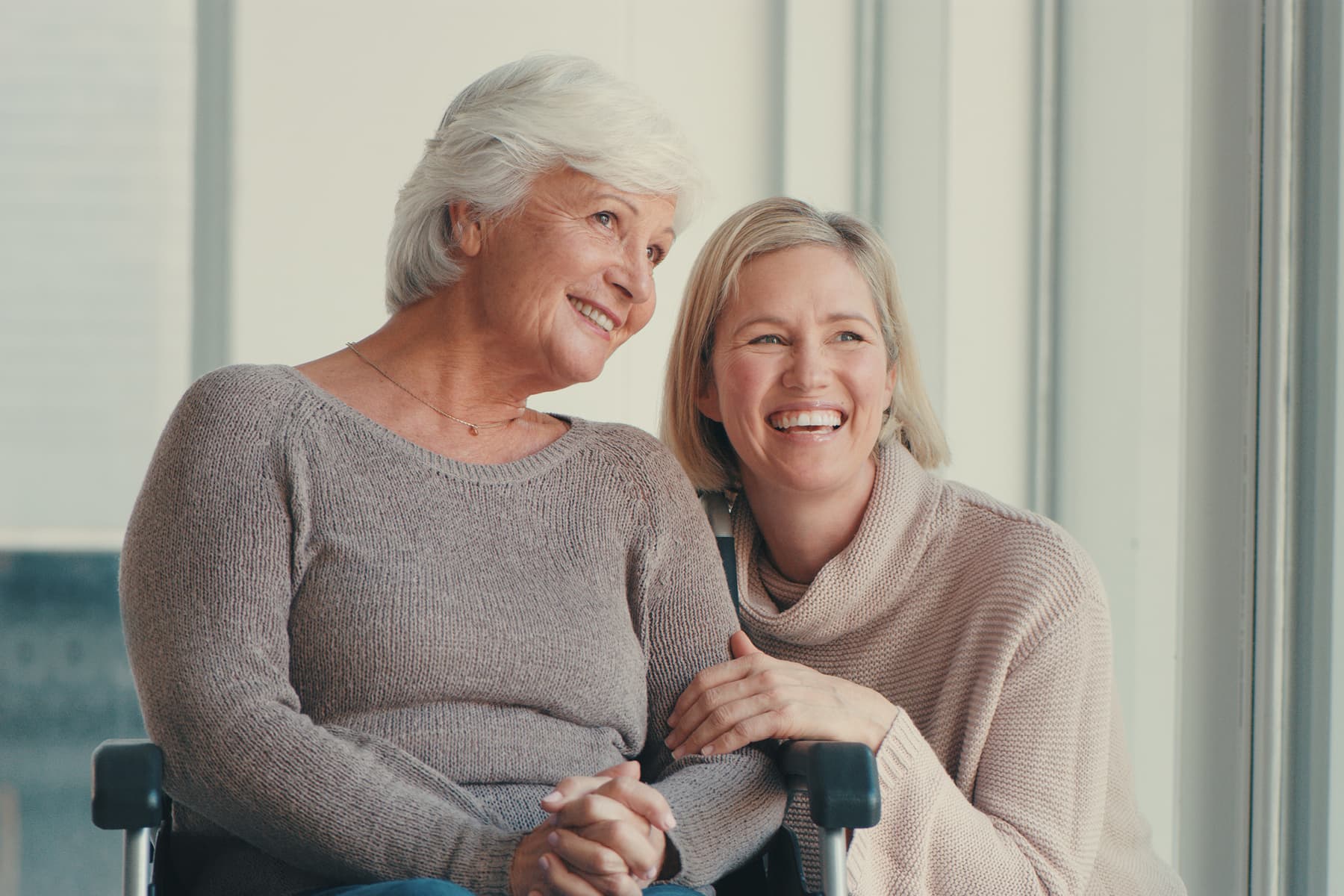 woman helping her mother communicate during a conversation at home