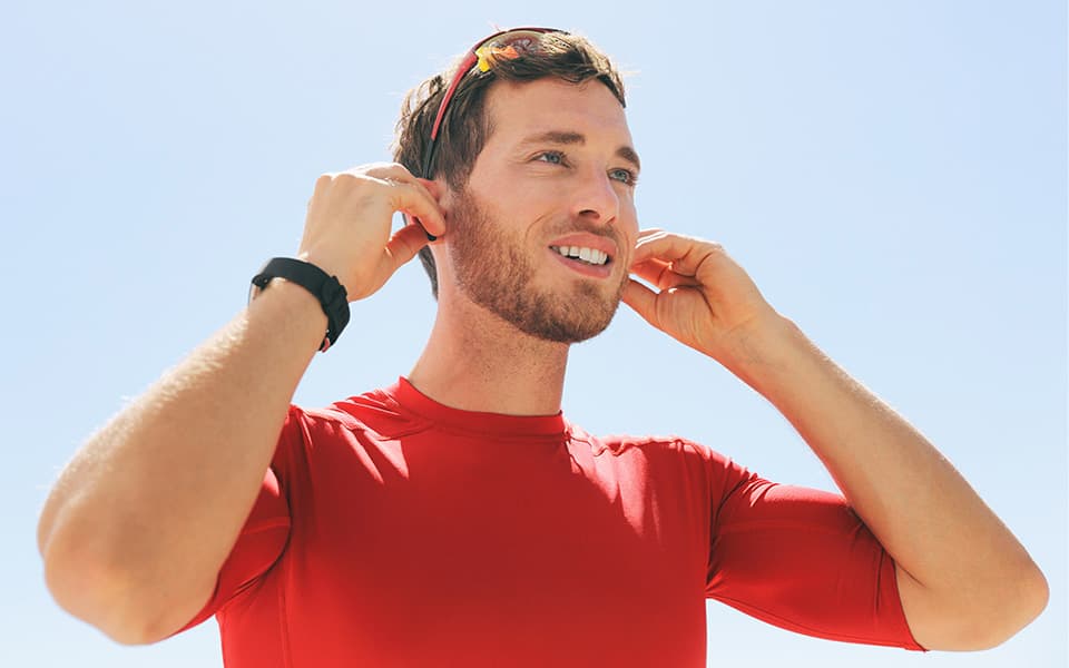 Man adjusting hearing aids