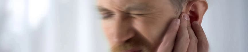 Man holding his ear in pain