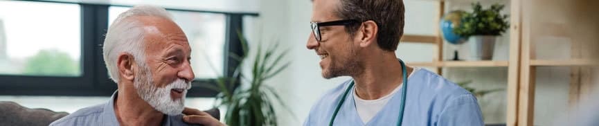 Man smiling while speaking to a doctor
